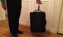luggage scales, suitcase being held by a man