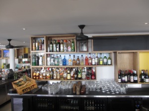 bar with shelves with bottles of alcoholic drinks