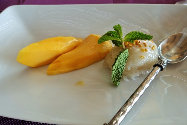 mango cheeks with sticky rice and a silver spoon